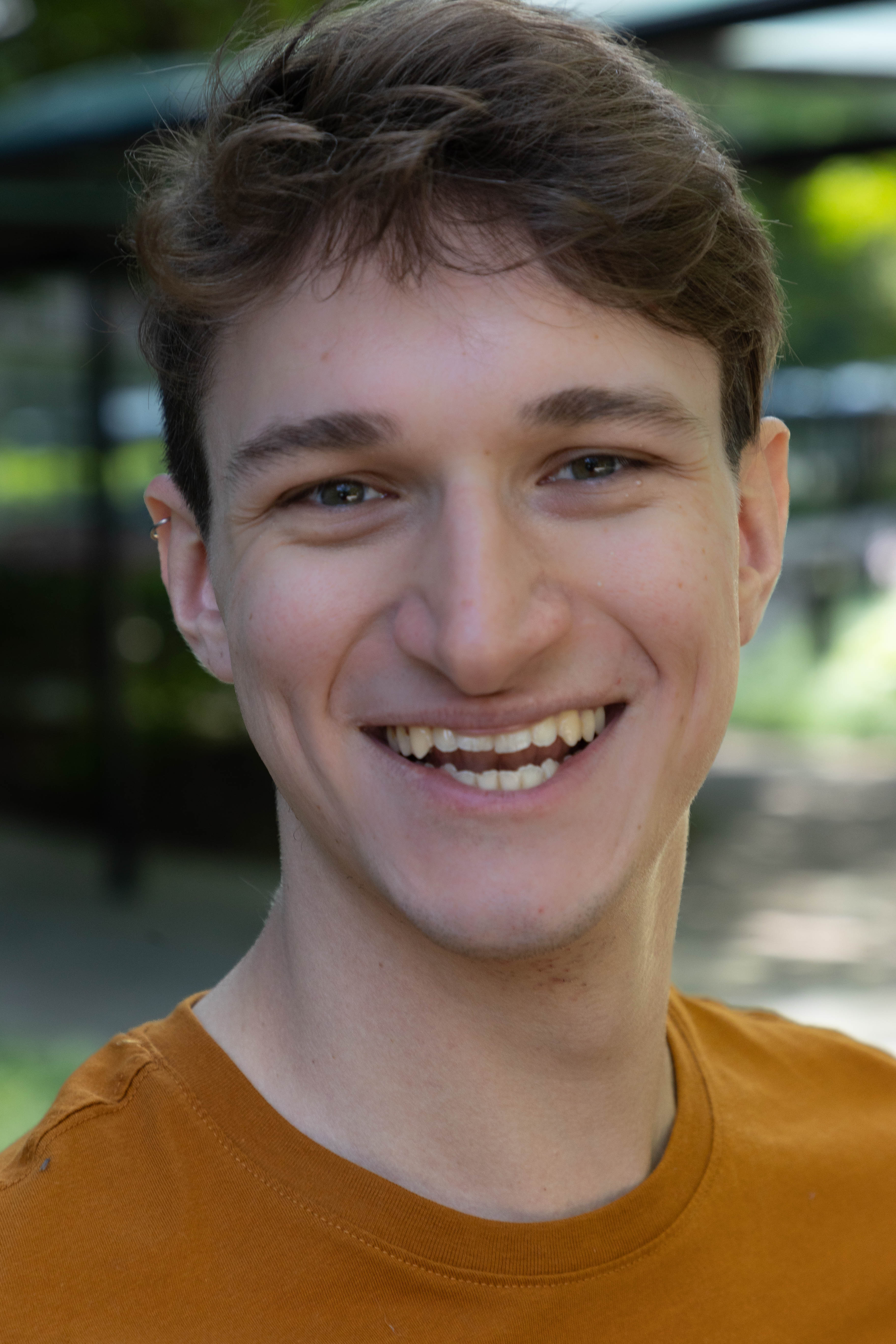Headshot 3: Orange Smiling outdoors